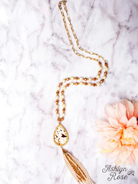 DON'T UNDERESTIMATE ME COWHIDE PENDANT WITH WHITE BEADED TASSELS ON A CRYSTAL GOLD CHAIN NECKLACE